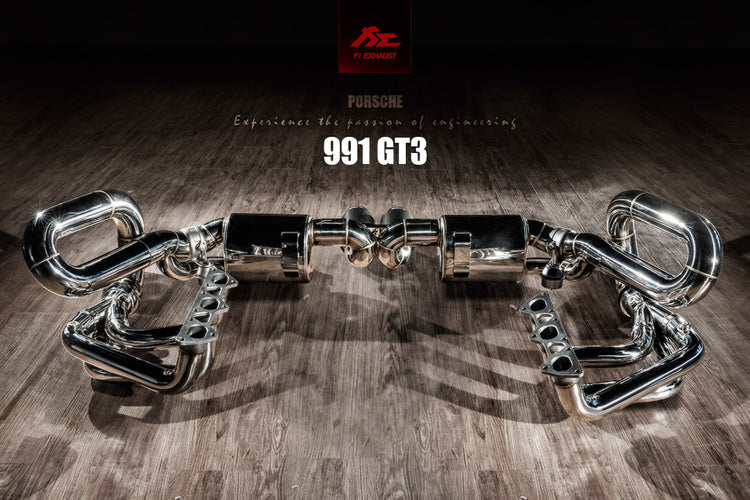 A top view of Fi EXHAUST Valvetronic Cat-Back System for Porsche 991.1 GT3 / RS 2013-2019 on a wooden floor