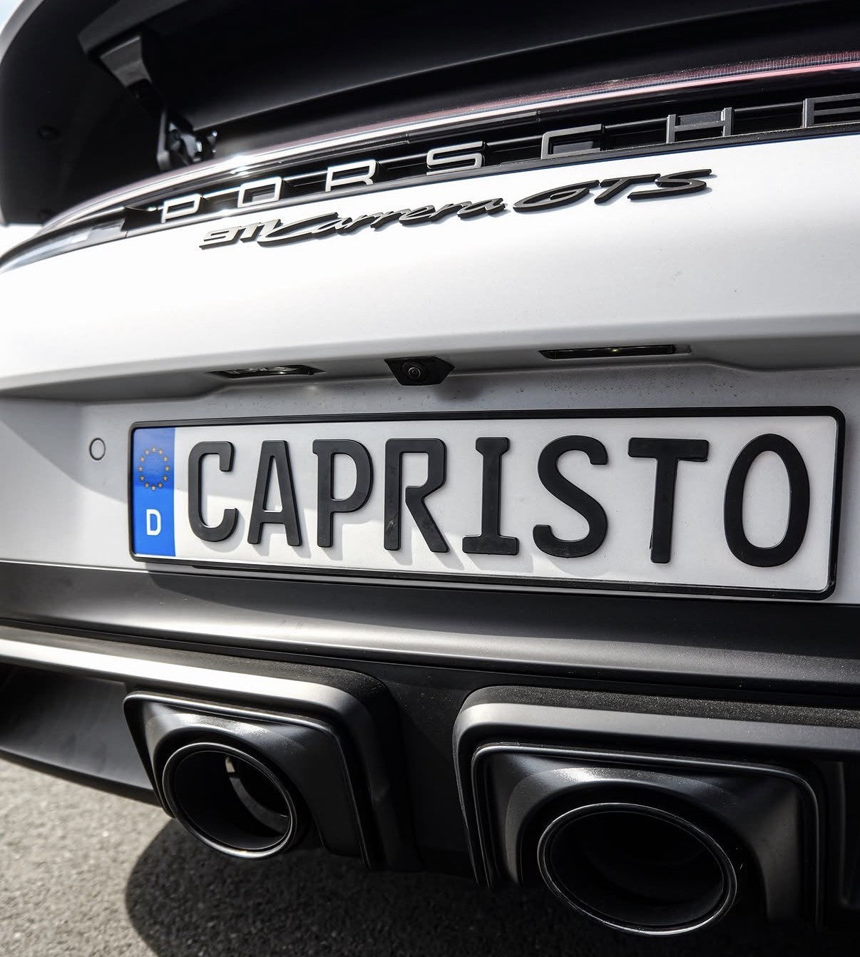 Close-up of black oval tailpipes on Porsche 992.2 Carrera GTS