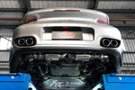 A back view of a lifted car fitted with FI Exhaust Valvetronic Cat-Back System For Porsche 997.2 Carrera / S 2009-2012