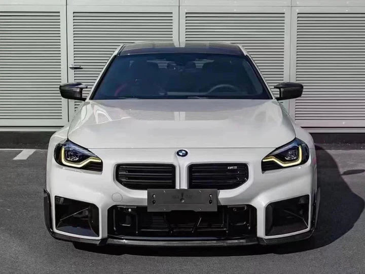 A front wide view of AUTOTECKNIC DRY CARBON PERFORMANTE FRONT LIP - BMW G87 M2 2023+ fitted on a car