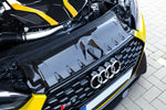 Capristo carbon fiber lock cover above the grille of a yellow Audi RS5 F5