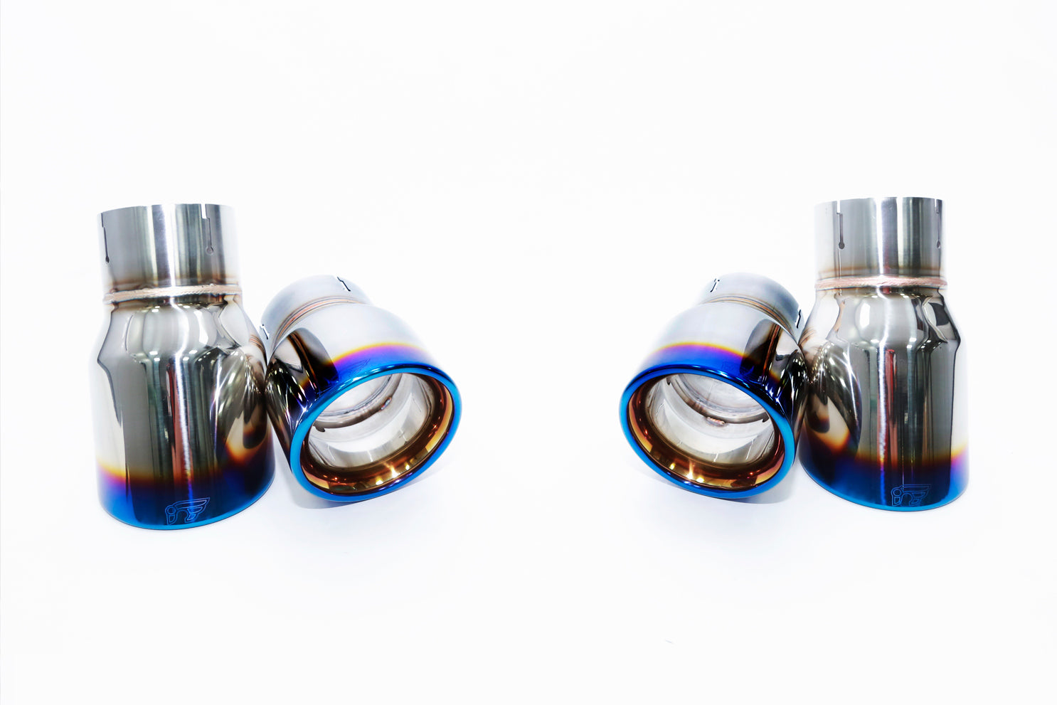 A front view of the Quad titanium blue tips of the IPE SS Cat-Back Exhaust System with Remote Control for Audi A6 / A7 C7 3.0 TFSI Quattro 2010-2017 on a white background