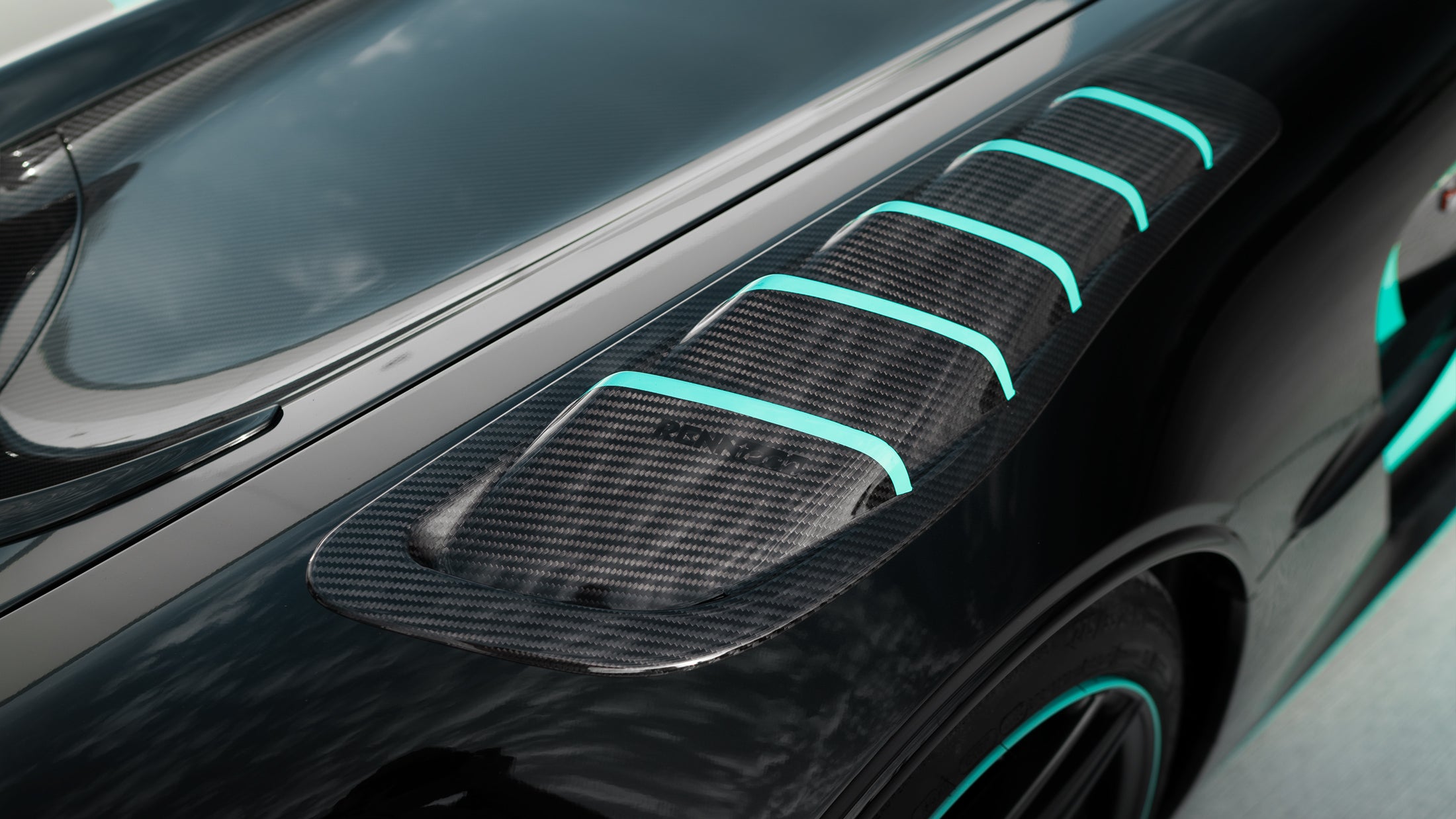 Extractor inserts fitted on the hood vents of a black car - Carbon Fender Extractor Inserts for the 2021 AMG GT Black Series