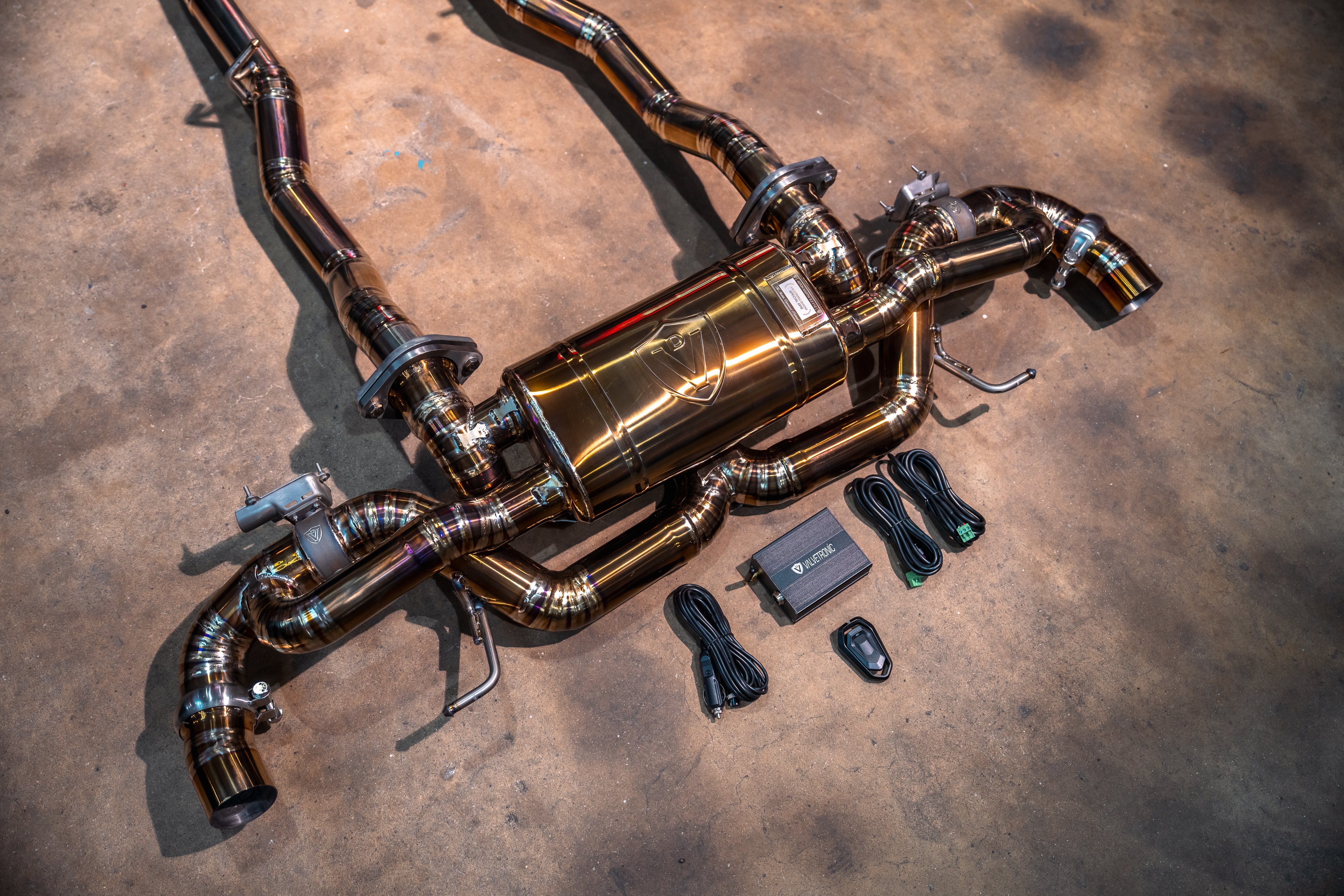 Valvetronic Designs Exhaust Aston Martin DB11 5.2L manufacturer gallery: rear muffler and control kit viewed diagonally