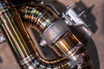 Valvetronic Designs Exhaust Aston Martin DB11 5.2L manufacturer gallery: valve housing and gold-toned rear muffler close-up