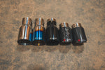 A top view of a five different styles of Valvetronic Designs Exhaust Tips on the ground.