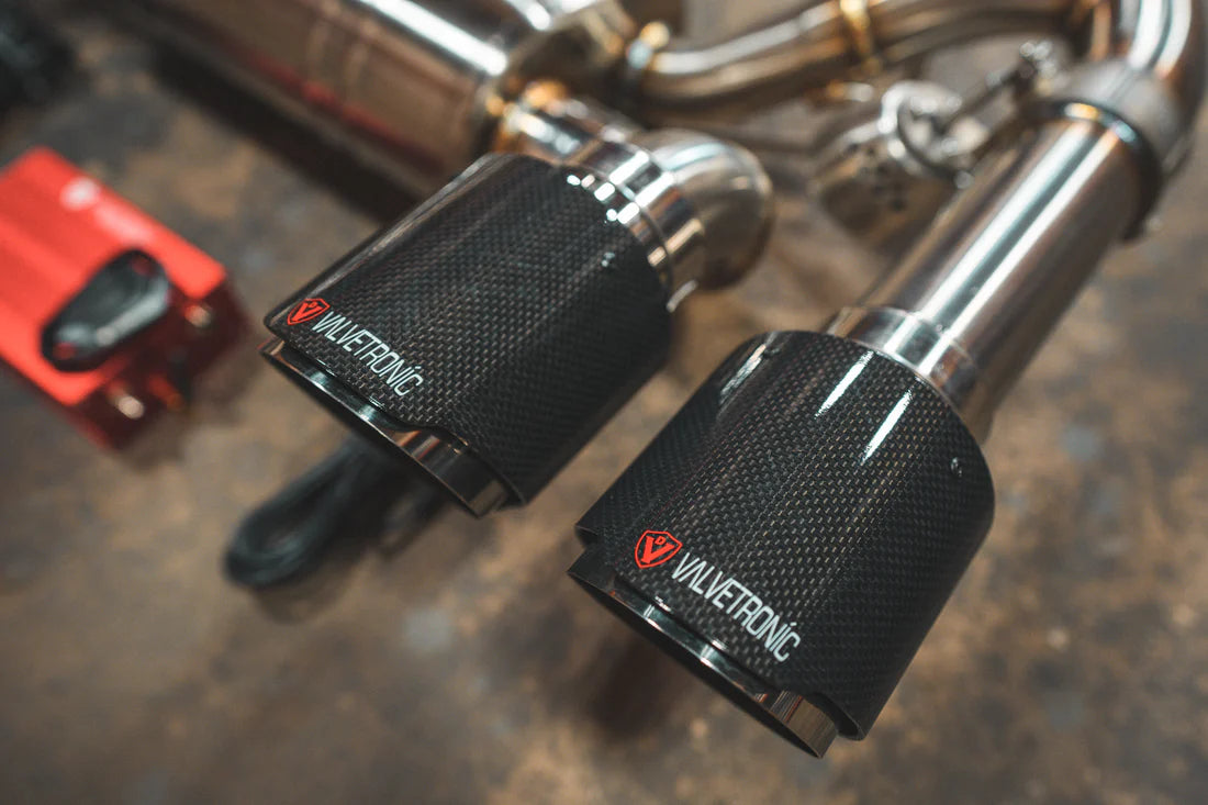 A close view of exhaust tips of Valvetronic Designs Valved Sport Exhaust System on the ground (for BMW F87 M2).