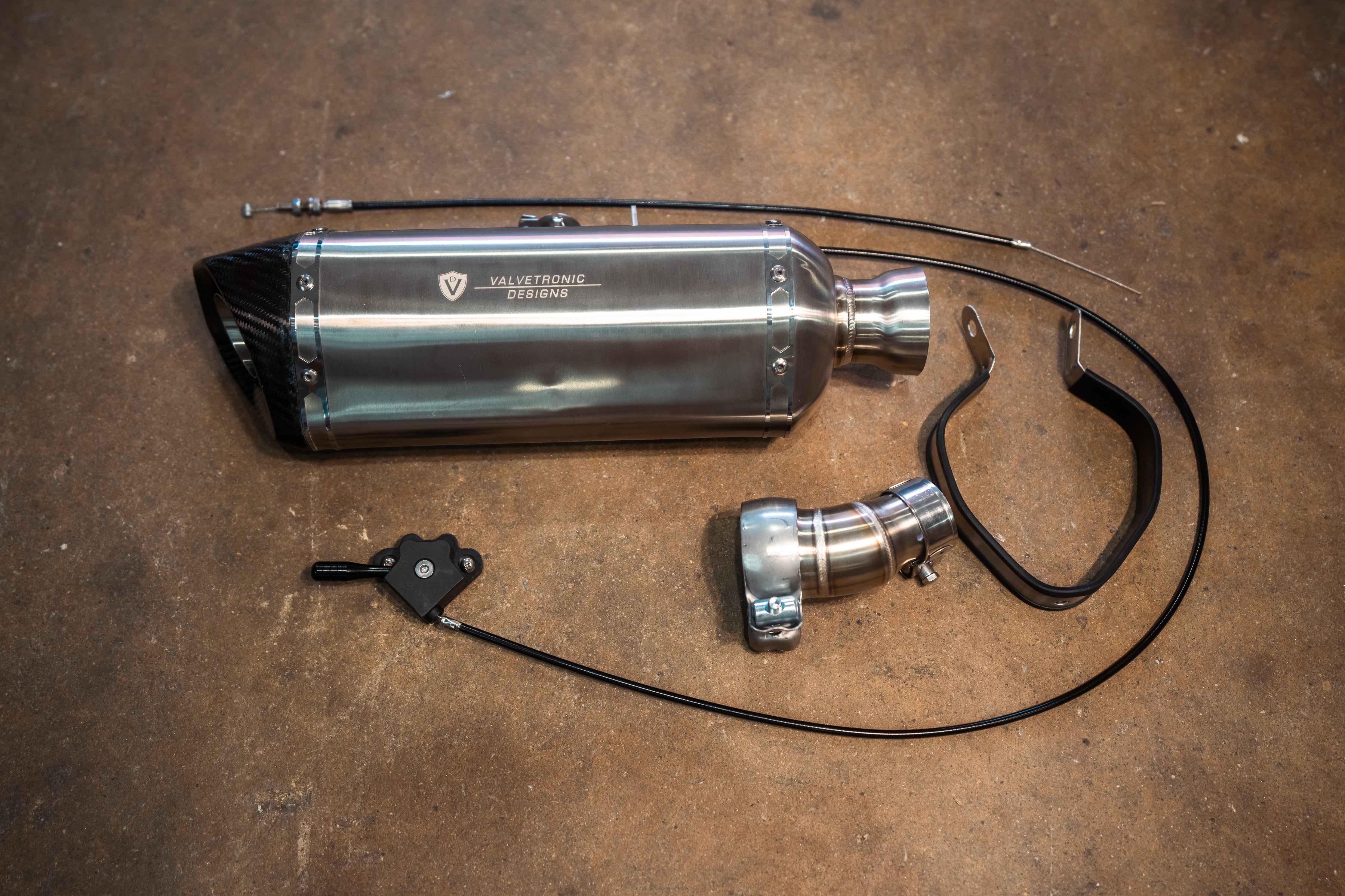Valvetronic Designs Motorcycle Valved Muffler manufacturer gallery: polished muffler, curved valve adapter, cable and lever laid out together