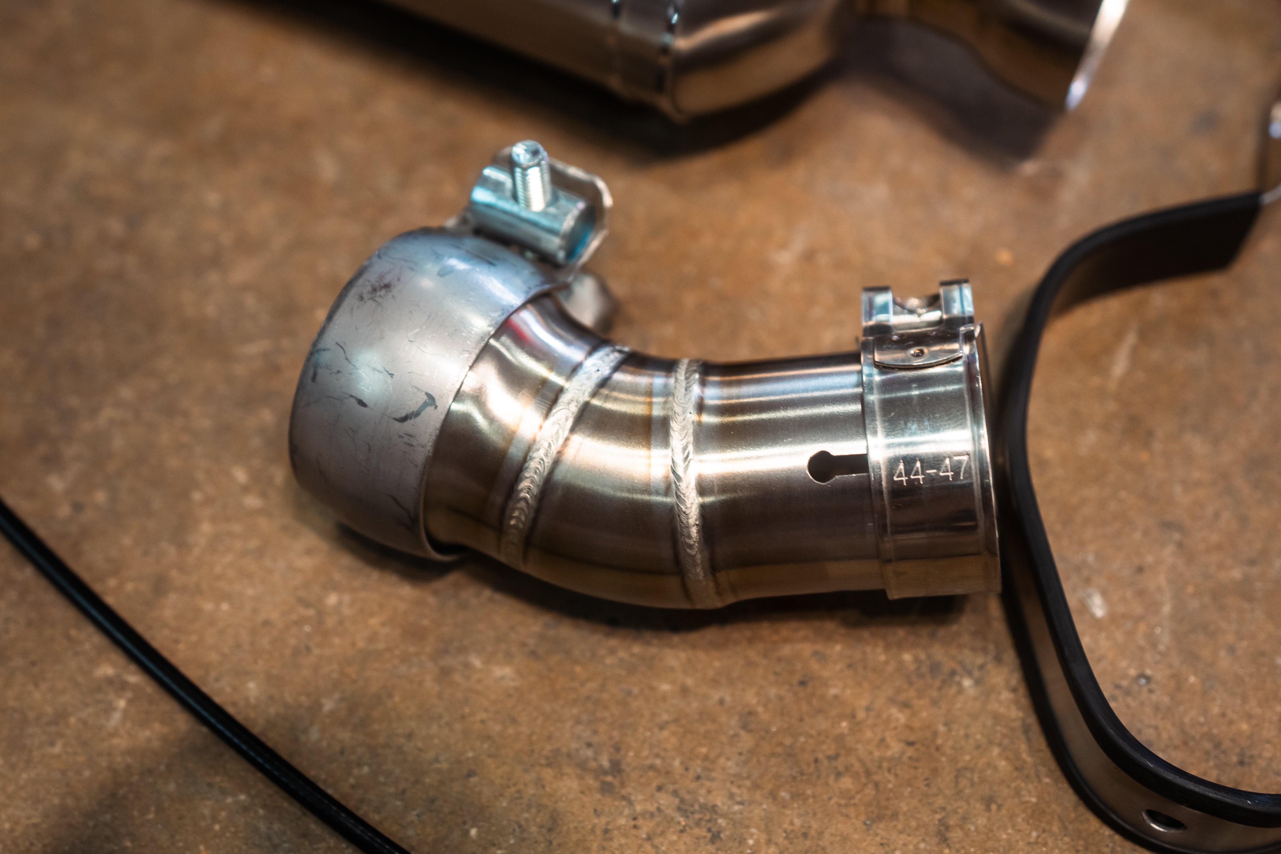 Valvetronic Designs Motorcycle Valved Muffler manufacturer gallery: curved valve adapter with clamp and mounting strap