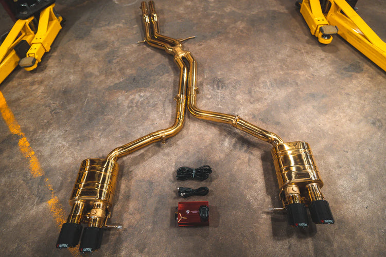A top overview of Valvetronic Designs Valved Sport Exhaust System (for Audi B8 / B8.5 S4 / S5) with wires on the ground. 
