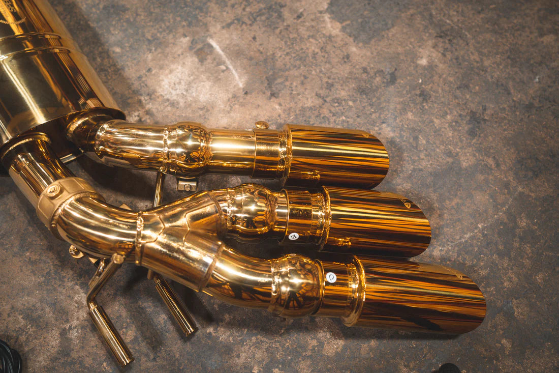 A close up view of Valvetronic Designs Valved Sport Exhaust System's exhaust tips on the ground (for Mercedes Benz G-Wagon G550, G63 / Squared).