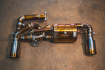 Valvetronic Designs Valved Exhaust Lotus Emira manufacturer gallery: rear muffler, curved branches and two metal outlets viewed overhead
