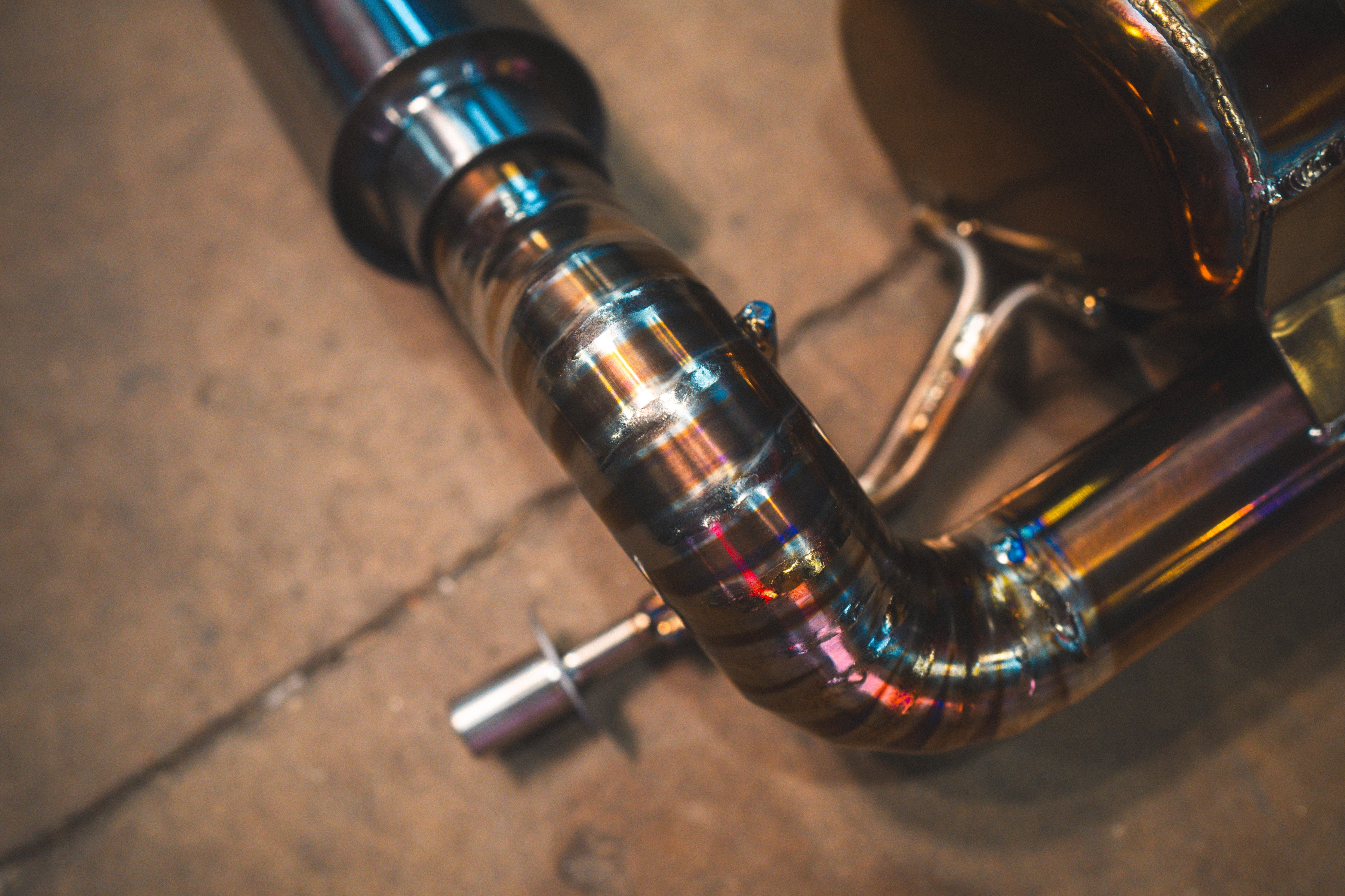 Valvetronic Designs Valved Exhaust Lotus Emira manufacturer gallery: segmented pipe bend and welded hanger beside the muffler