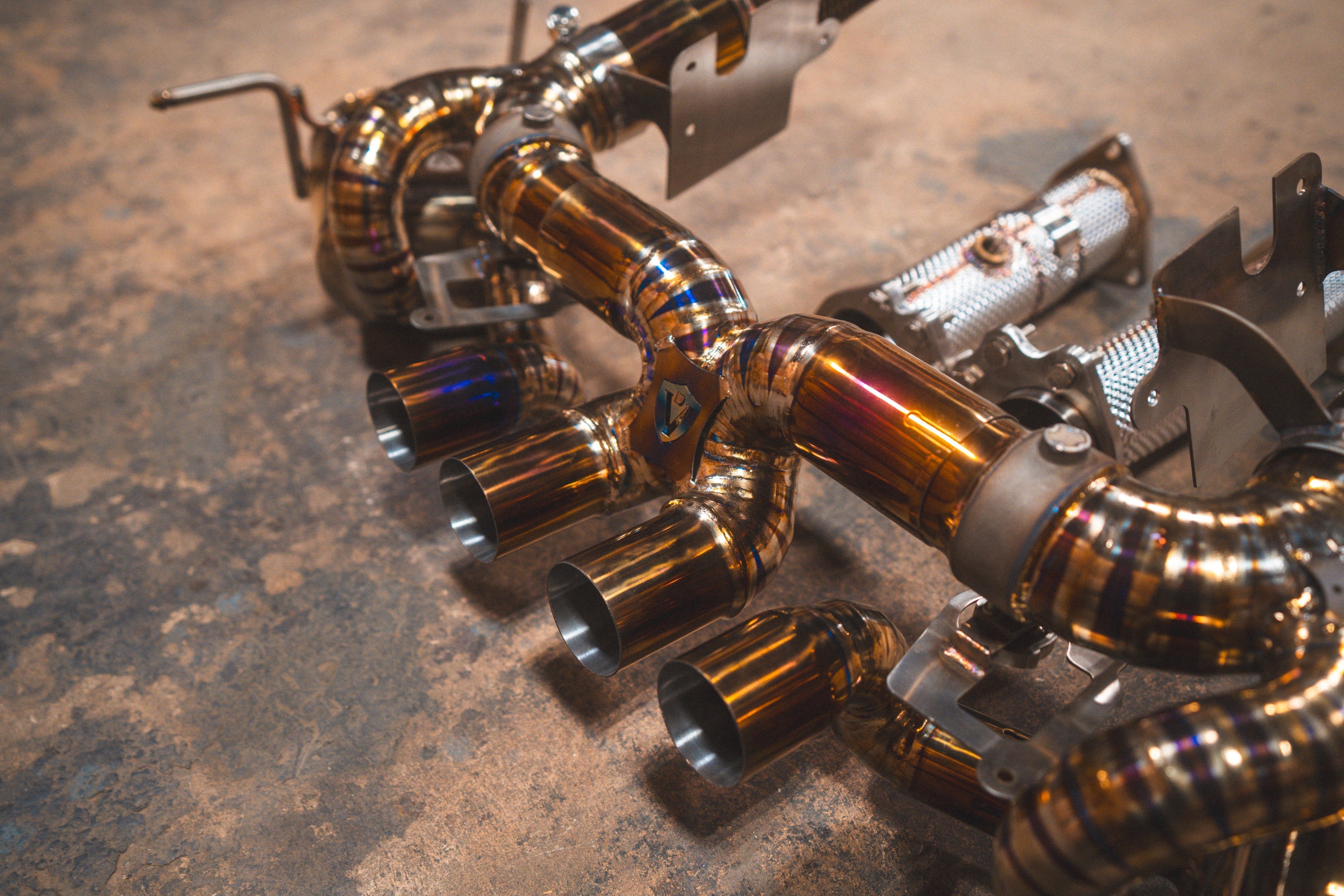Valvetronic Designs Valved Exhaust Corvette C8 Z06 manufacturer gallery: exhaust and shielded front components viewed diagonally