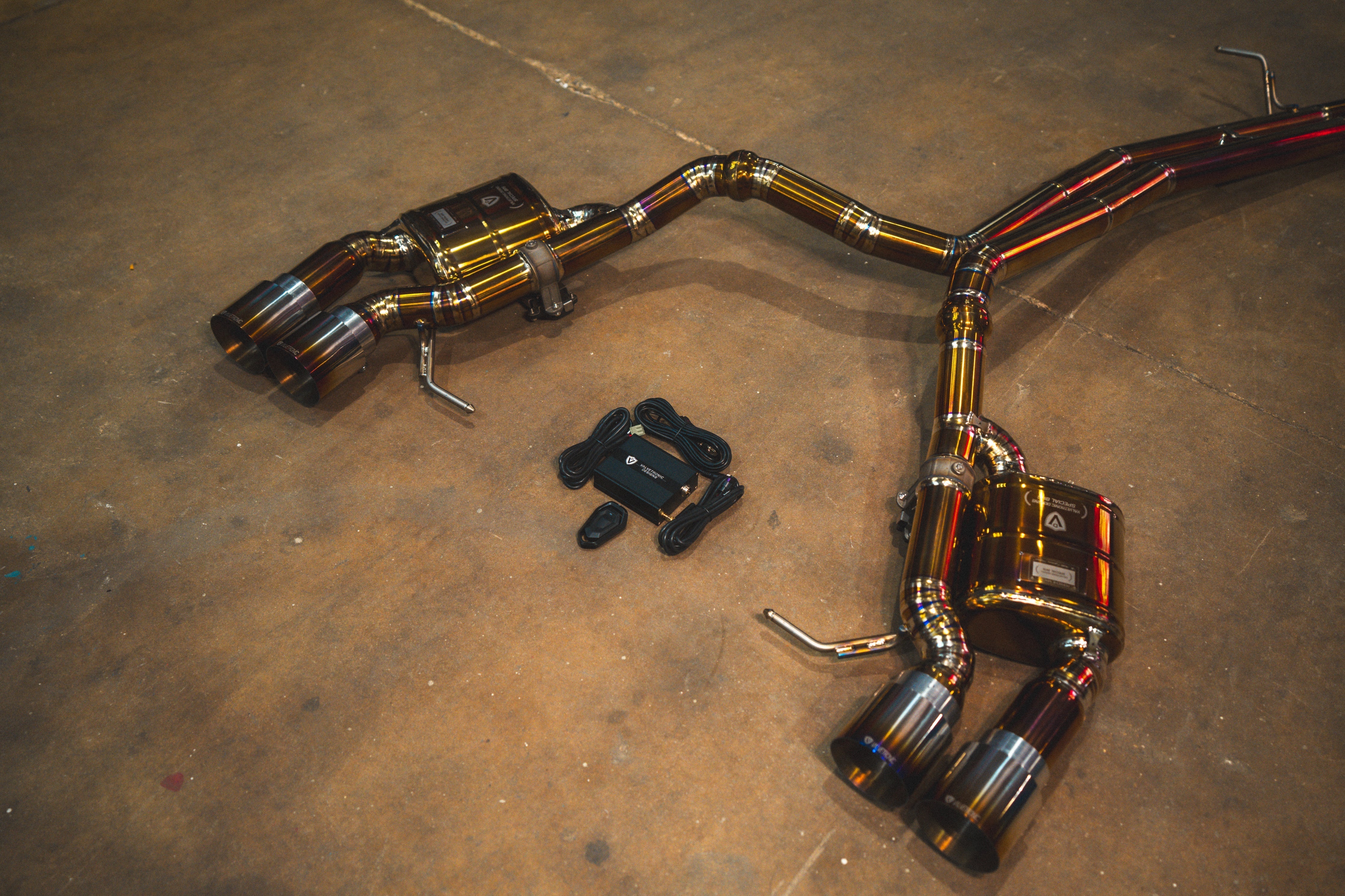 Valvetronic Designs Valved Exhaust Porsche Macan manufacturer gallery: rear mufflers and controller viewed diagonally