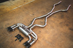 Valvetronic Designs Exhaust BMW F85 X5M / F86 X6M manufacturer gallery: complete exhaust laid diagonally across the workshop floor
