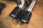 Valvetronic Designs Exhaust BMW F85 X5M / F86 X6M manufacturer gallery: pair of dark carbon-pattern outlet tips viewed close-up