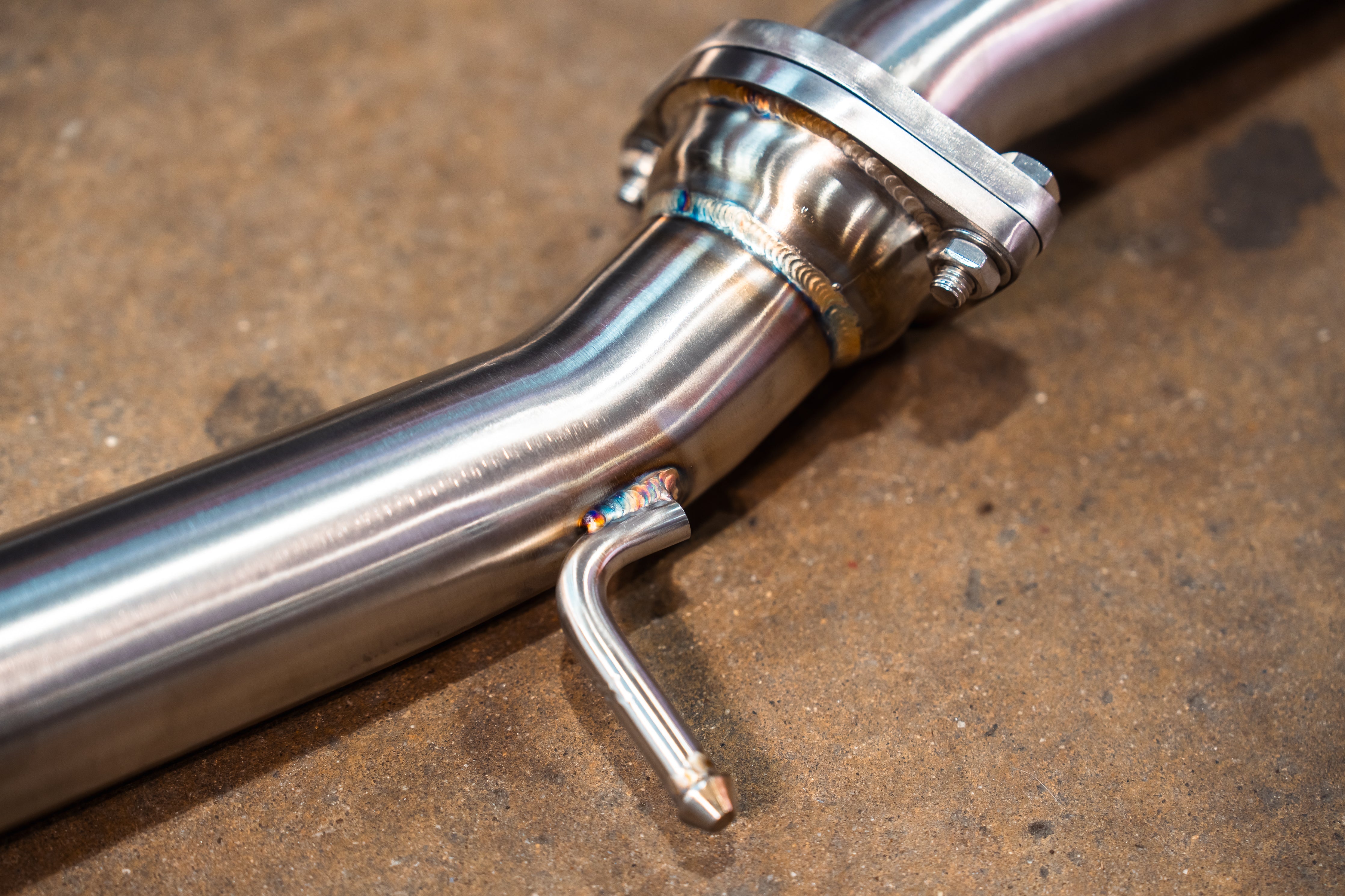 Valvetronic Designs Valved Exhaust Lexus RC F manufacturer gallery: front pipe flange and bent hanger viewed diagonally