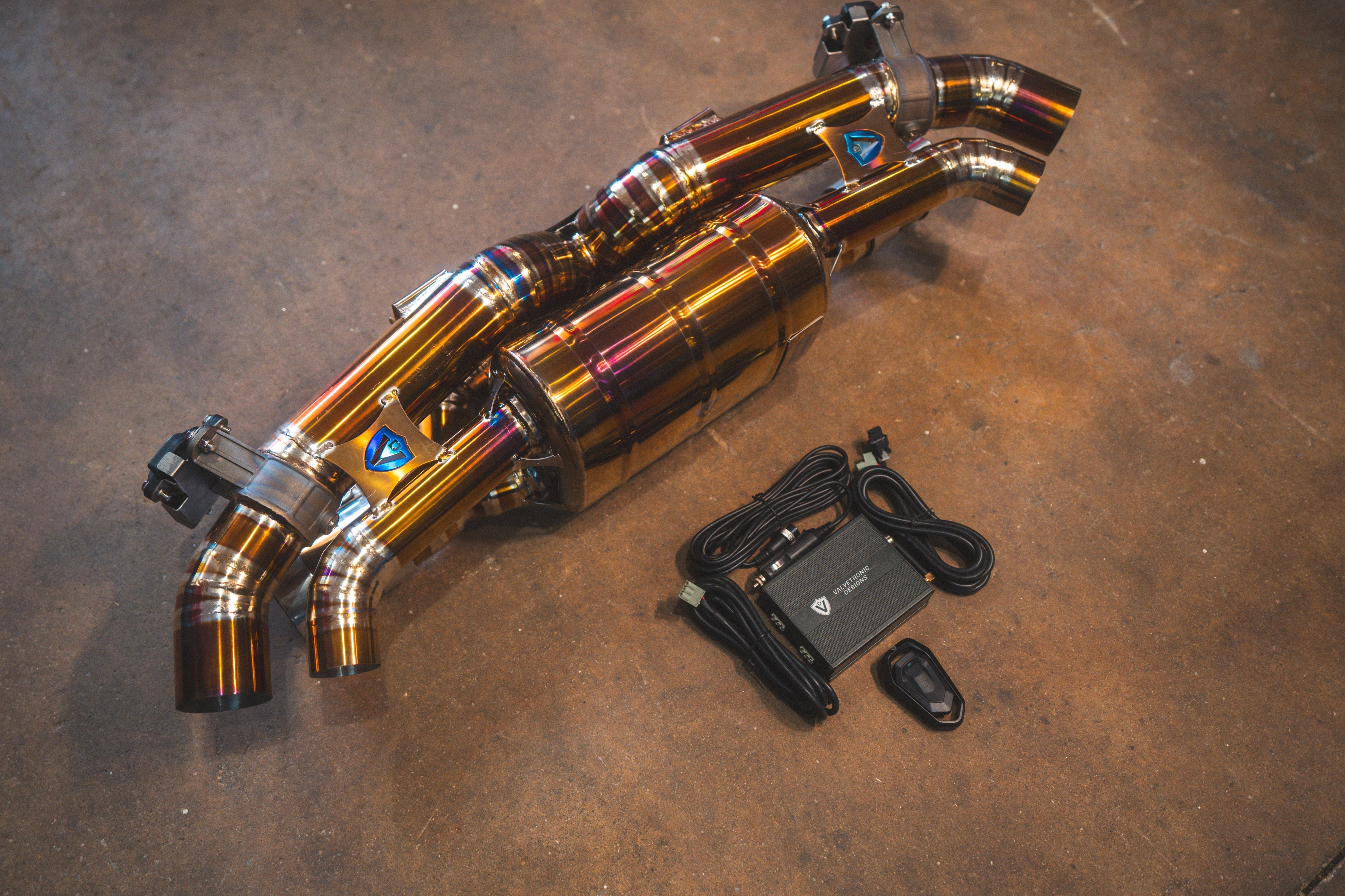 Valvetronic Designs Exhaust Porsche 992 Carrera / Turbo manufacturer gallery: rear muffler laid diagonally beside the controller