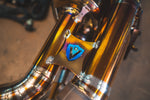 Valvetronic Designs Exhaust Porsche 992 Carrera / Turbo manufacturer gallery: blue shield brace between parallel gold-toned tubes