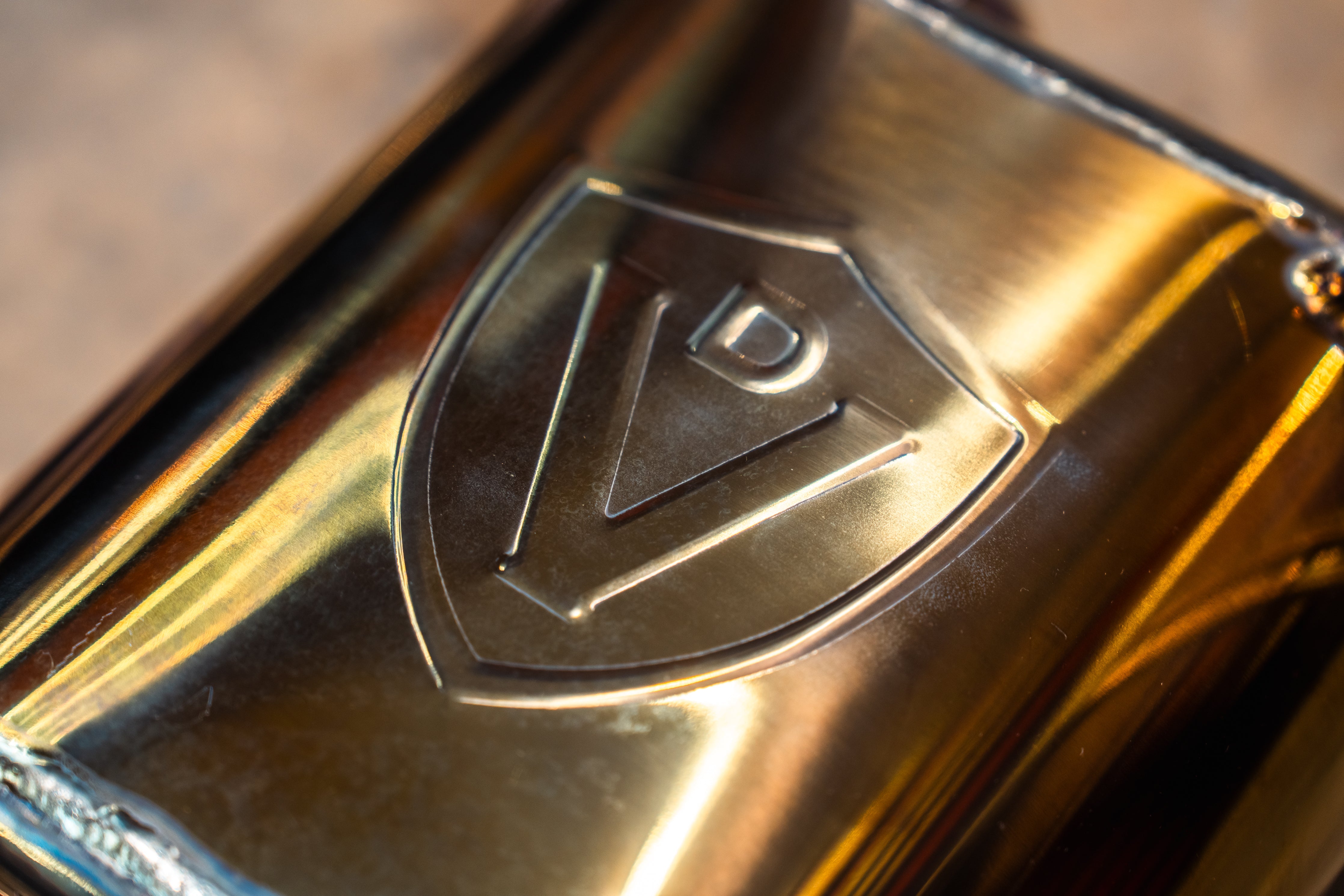 Valvetronic Designs Valved Exhaust Subaru WRX FA20 manufacturer gallery: embossed shield on the gold-toned muffler