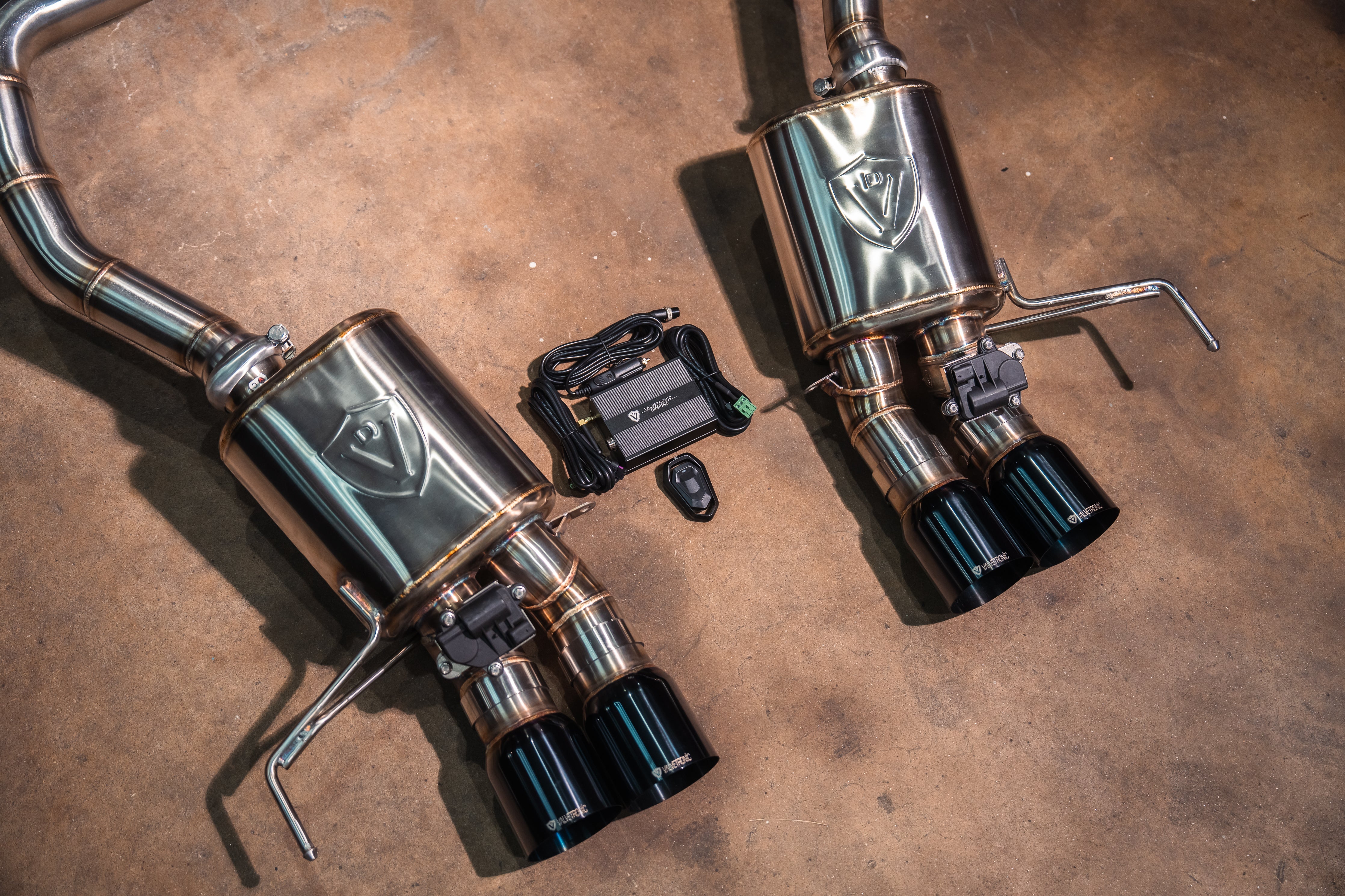 Valvetronic Designs Valved Exhaust Corvette C7 manufacturer gallery: twin rear mufflers and paired black tips viewed diagonally