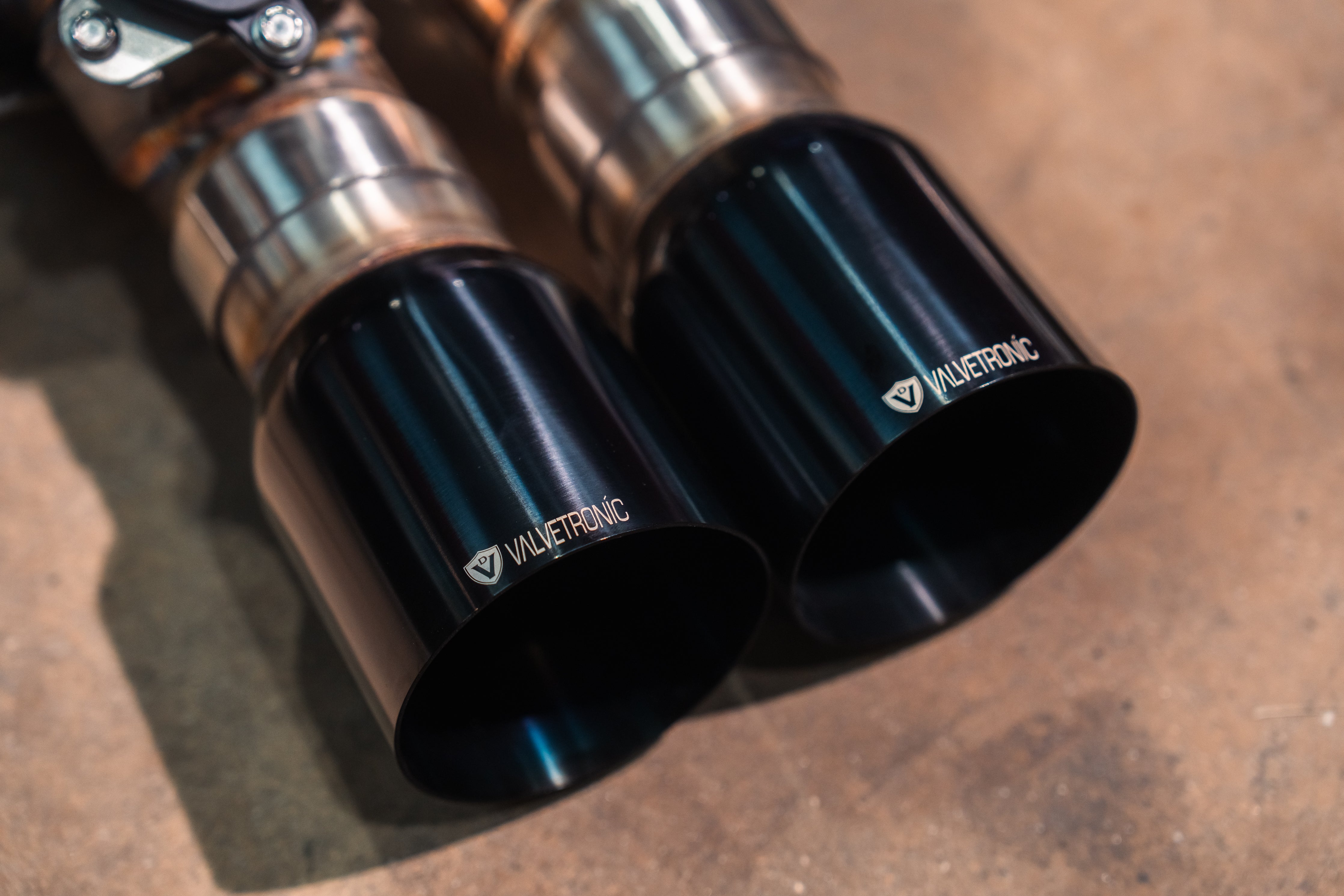 Valvetronic Designs Valved Exhaust Corvette C7 manufacturer gallery: two glossy black outlet tips viewed close-up