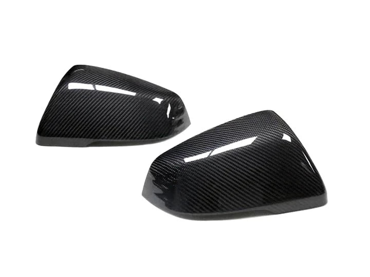 A front view of AUTOTECKNIC REPLACEMENT VERSION II DRY CARBON MIRROR COVERS - TOYOTA A90 SUPRA 2020+ with white background