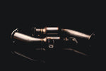 AMS street lower downpipes for the Infiniti Q50 and Q60 laid out on a dark background