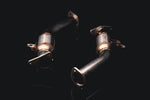 Both AMS catted lower downpipes from above, showing the inlet flanges and GESI converter bodies