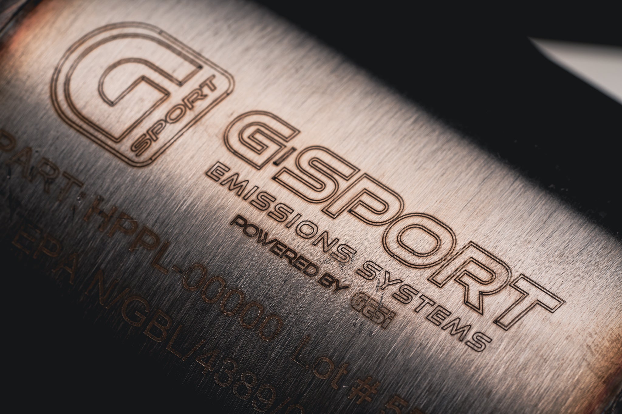 GESI G-Sport Emissions Systems logo etched on the catalytic converter of an AMS street downpipe