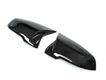 A side view of AUTOTECKNIC REPLACEMENT AERO CARBON MIRROR COVERS - TOYOTA A90 SUPRA 2020+ with white background