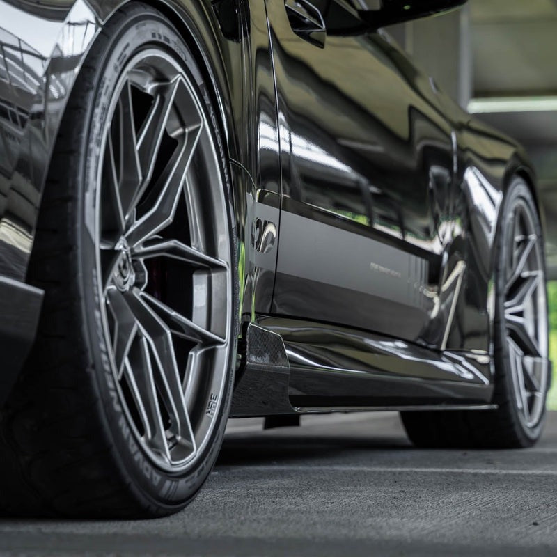 wide side view of TRE Carbon Fiber Side Skirts for BMW G87 M2 TR87 2023+ fitted inside a car