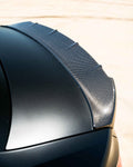A side close up view of a black car fitted with Urban Automotive Carbon Fiber Rear Lip Spoiler Audi RS3 8Y 2022+