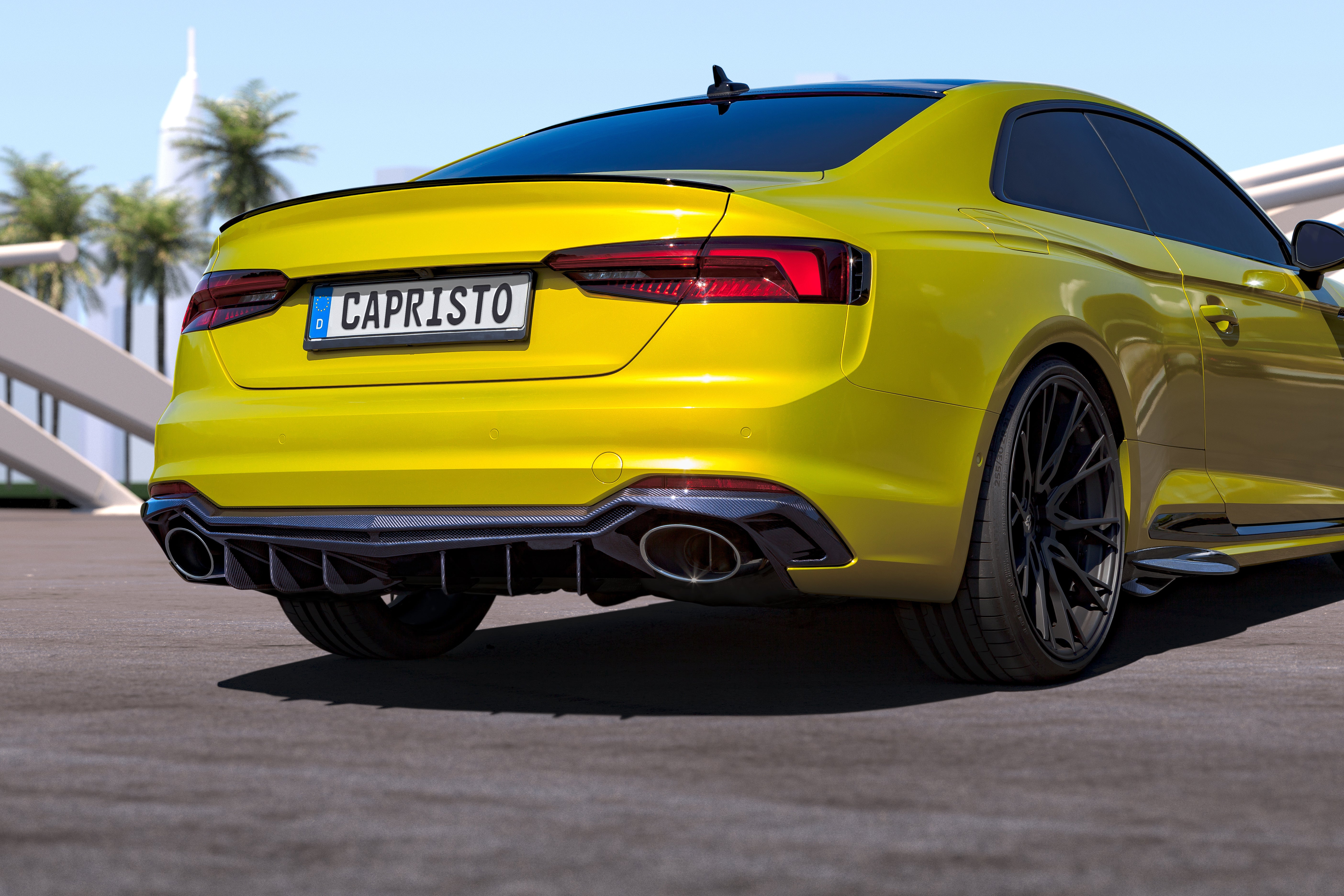 Yellow Audi RS5 coupe rear three-quarter with Capristo carbon diffuser