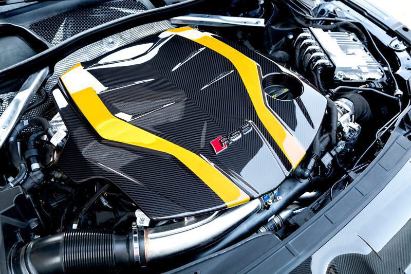 Close-up of Capristo carbon fiber engine cover with yellow stripes on Audi RS5 F5