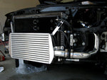 A side view of Polished Evolution Racewerks Audi A4 (B7) Competition Series Front Mount Intercooler (FMIC) Kit installed in a car