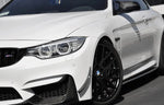 A side close up view of AUTOTECKNIC FRONT BUMPER DRY CARBON CANARD SET - BMW F80 M3 | F82/ F83 M4 2014+ fitted on a white car