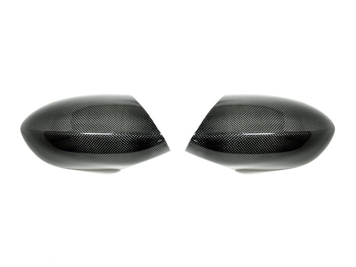 A front view of AUTOTECKNIC REPLACEMENT CARBON FIBER MIRROR COVERS - BMW E9X M3 | E82 1M 2007-2013 with white background
