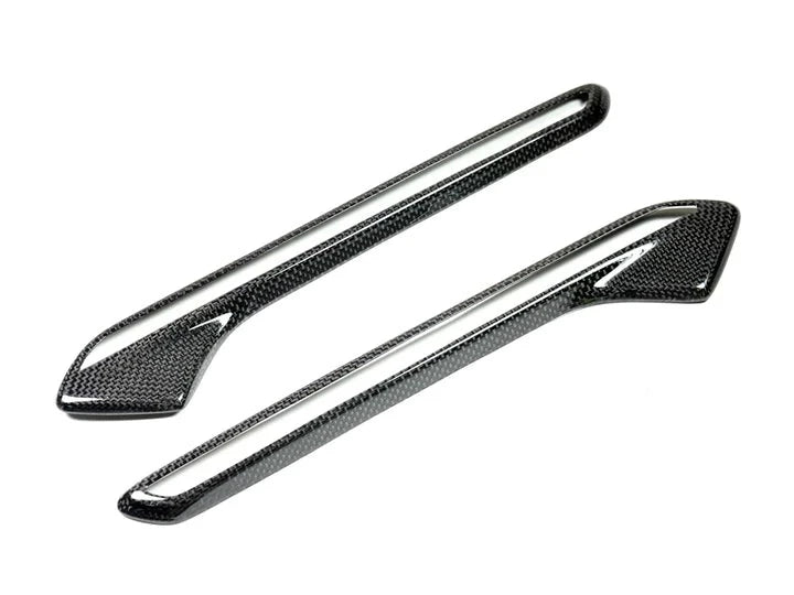 A front view of AUTOTECKNIC DRY CARBON FENDER LIGHT TRIM SET - BMW F06 / F12 / F13 M6 2011-2018 with white background