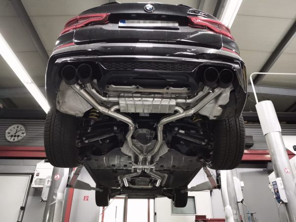 wide view of Capristo Exhaust Exhaust System, OPF Delete Mid Pipes, and Carbon Fiber Tips for BMW X3M Competition 2019-2022 fitted inside a car