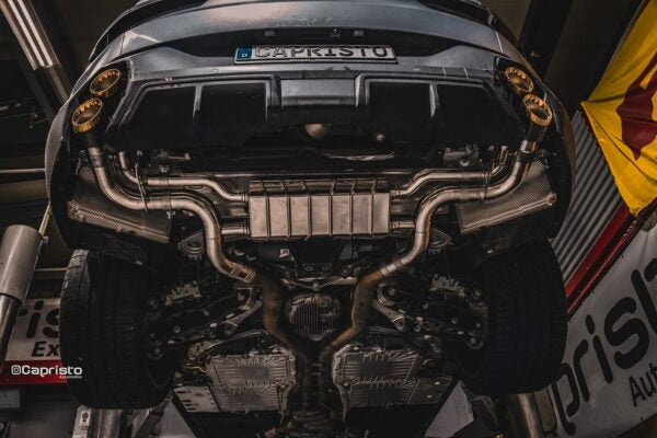 Wide view of Capristo Valved Exhaust System with Anodized/Wicrom Tips (for OE Actuators) for BMW XM 2023+ fitted inside a car