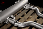 A close up view of Fi EXHAUST Valvetronic Cat-Back System for BMW G80 M3 / G82 M4 Titanium 2021+ muffler on wooden crate