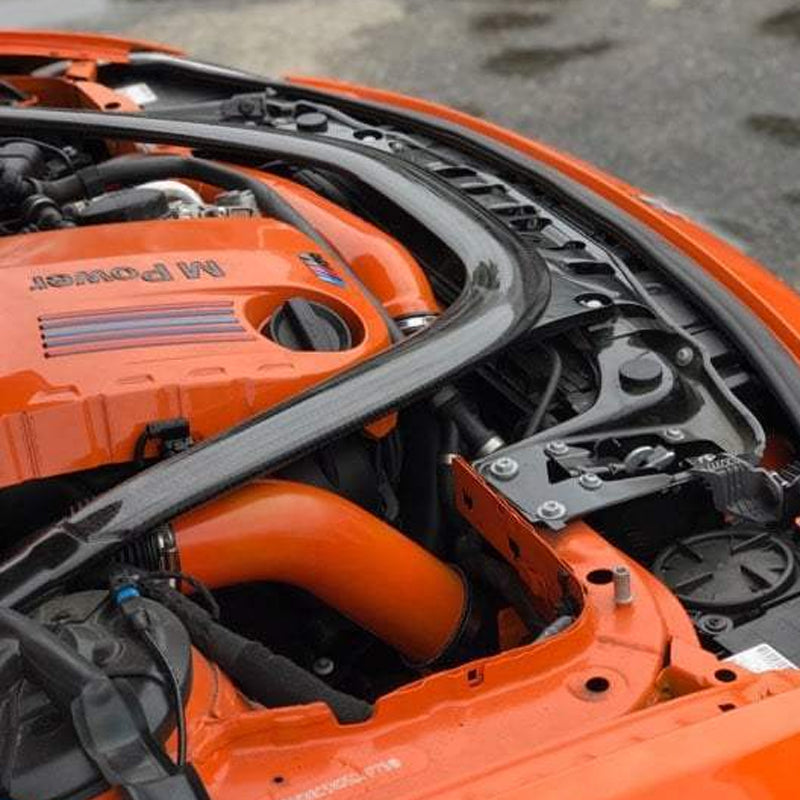 VRSF front facing intake tube passing through the front of an orange BMW M3 engine bay