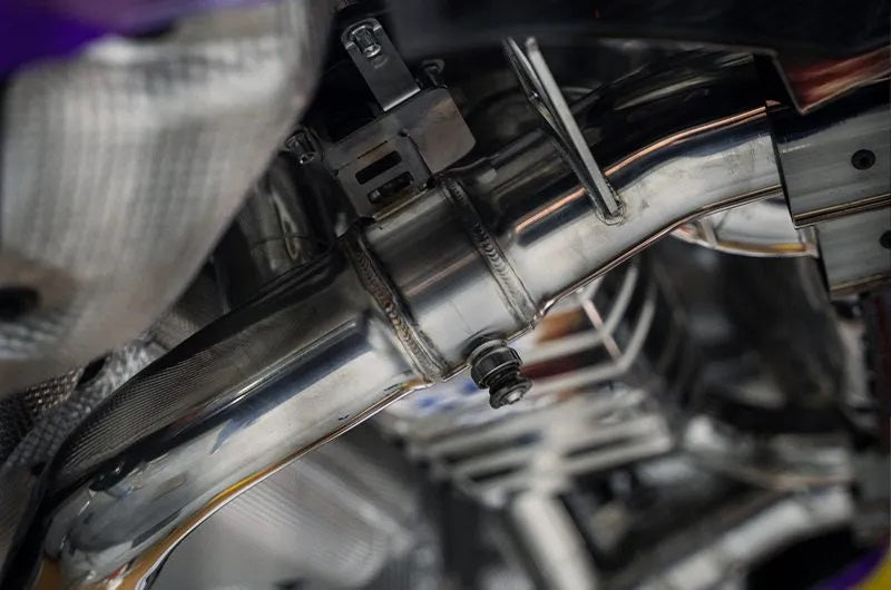 Close-up of Capristo M2 G87 exhaust pipe weld and hanger