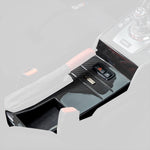 E46 M3 V-CSL center console, faded view highlighting carbon trim