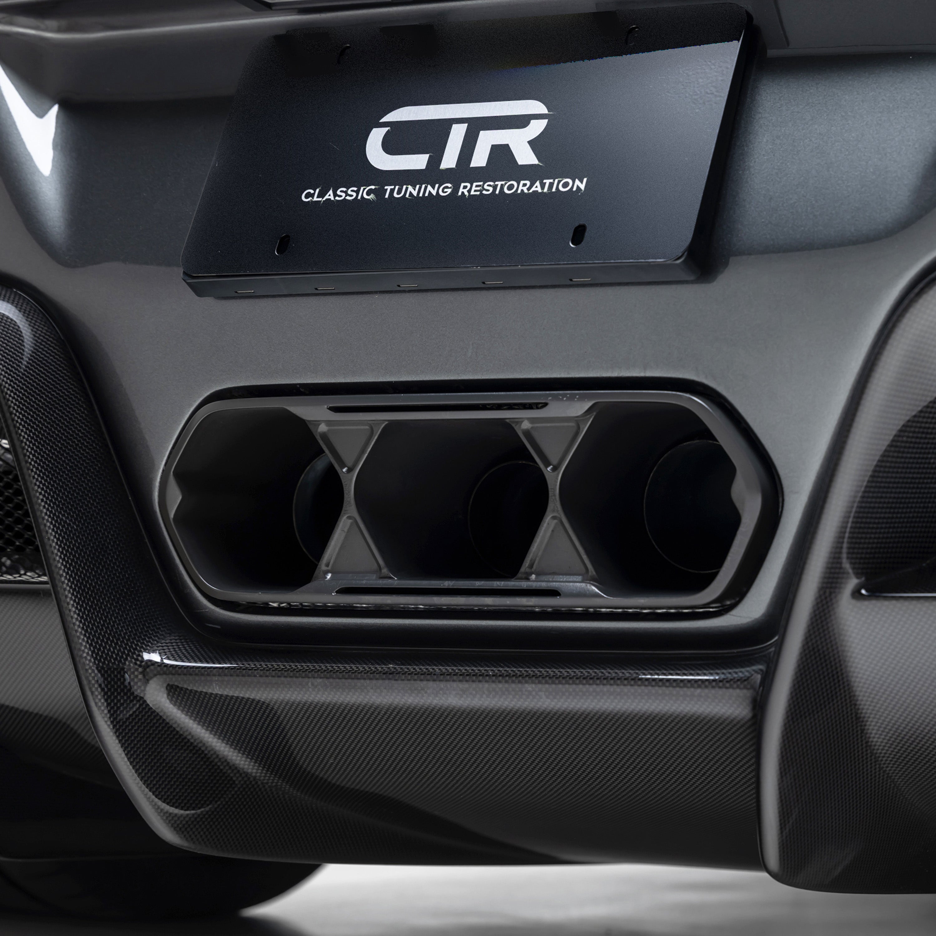 CTR triple exhaust surround and plate, close-up