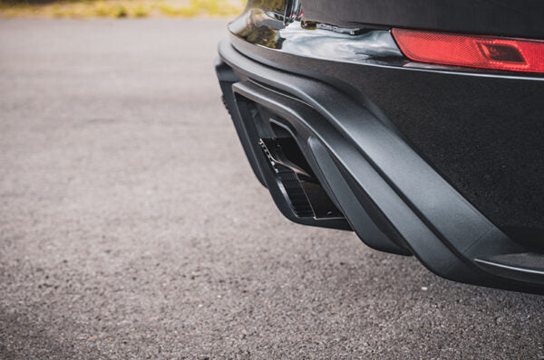 close side view of Capristo OPF Replacement 100 Cell Valve Muffler & Performance Headers Set with Wicrom Tips for Porsche 718 GT4RS 2021-2025 fitted inside a car