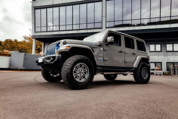 wide view of Capristo Triple Tip Valved Exhaust with 250 Cell Sport Cat Downpipes for Jeep Wrangler 4xe 2021+ fitted inside a car