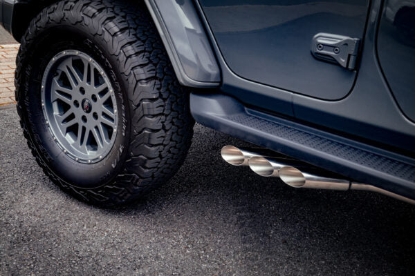 close view of Capristo Triple Tip Valved Exhaust with 250 Cell Sport Cat Downpipes for Jeep Wrangler 4xe 2021+ fitted inside a car